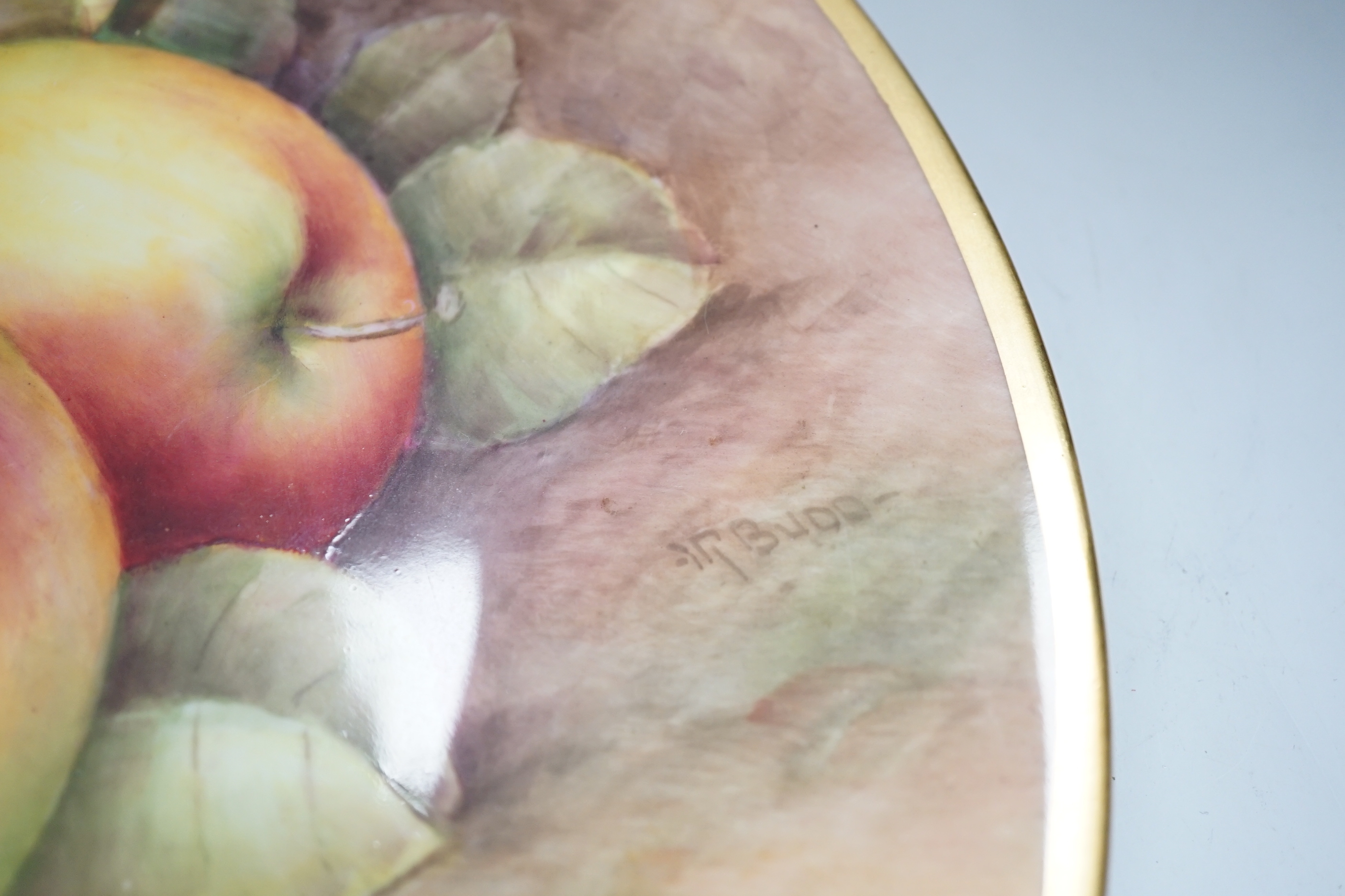 A large fruit painted dish by R. Budd and a Royal Worcester fruit painted miniature tea cup and saucer painted by F Harper and W H Austin, largest 32cm in diameter